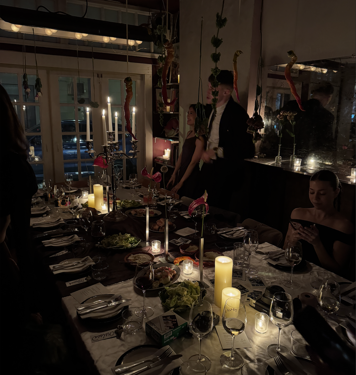 Long candlelit table set for an investor dinner