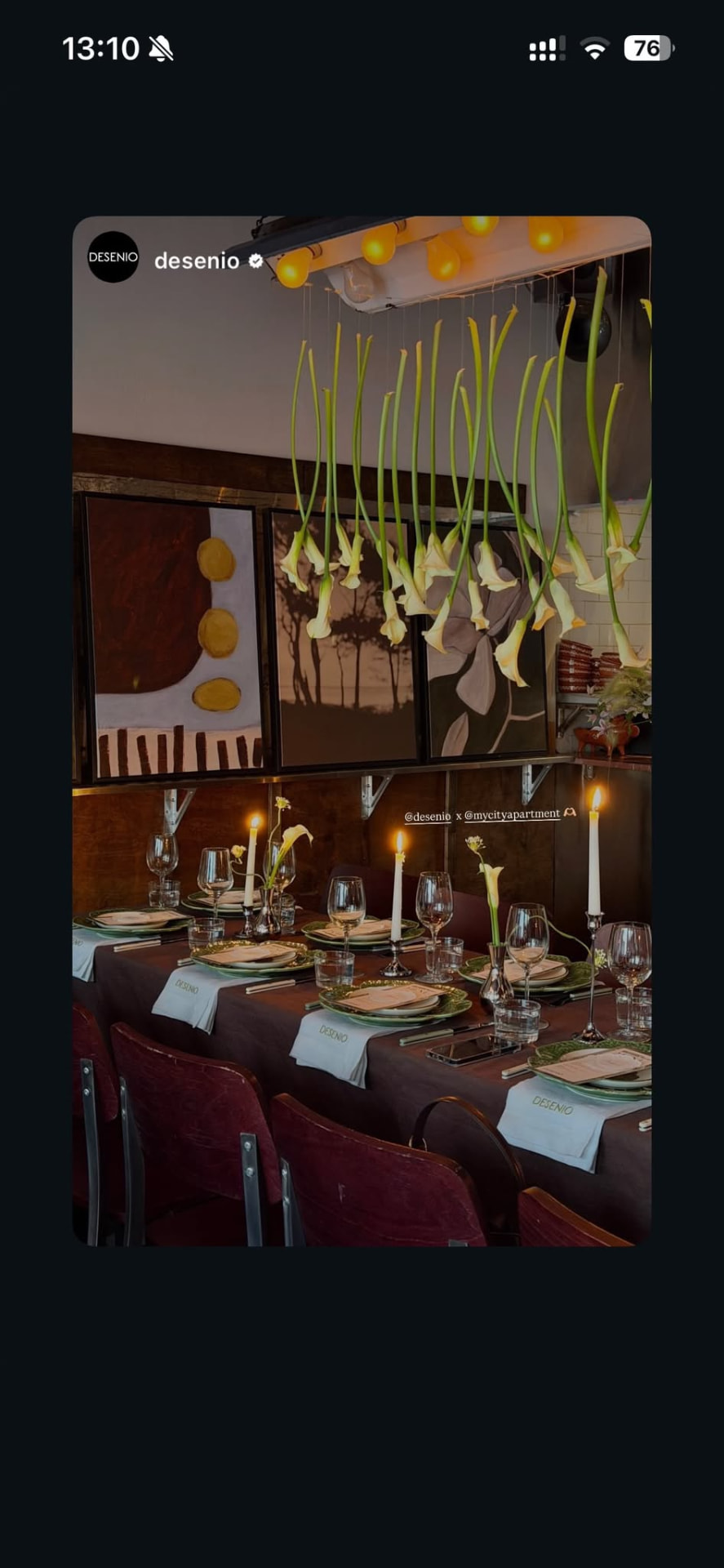 Candlelit Desenio event dinner with hanging floral installation