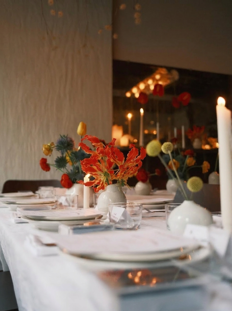 Intimate candlelit dining table with sculptural florals